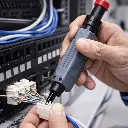 IT technician connecting LAN wires to patch panel.webp