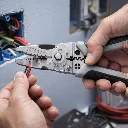 Electrician stripping wire with pliers.webp